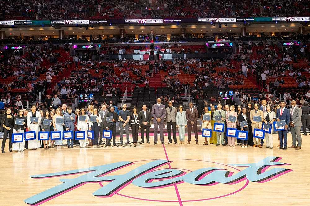 Miami HEAT Game with 15 scholarship winners on the court.